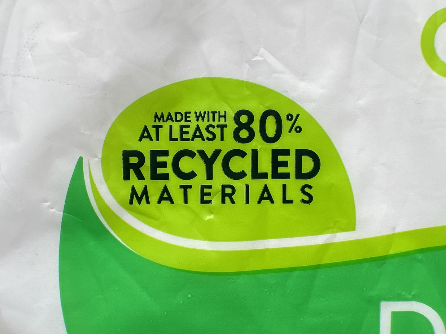 The plastic wrapping on a stack of paper plates reads "Made with at least 80% recycled materials".